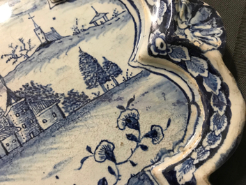 A Dutch Delft blue and white plaque with a lady in a landscape, 18th C.
