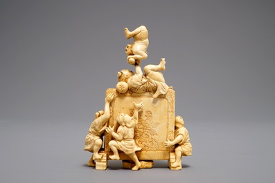 A Japanese carved ivory okimono with oni around a screen, signed, Meiji, 19th C.