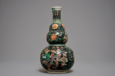 A Chinese black-ground famille verte double gourd dragon vase, 19th C.