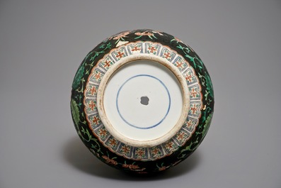 A Chinese black-ground famille verte double gourd dragon vase, 19th C.