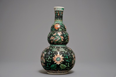 A Chinese black-ground famille verte double gourd dragon vase, 19th C.