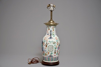 A Chinese famille rose vase with applied design mounted as a lamp, 19th C.