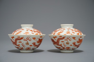 A pair of Chinese iron red dragon bowls and covers, Xianfeng mark, 19/20th C.