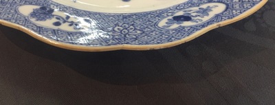 A pair of Chinese blue and white plates with animals in a garden, Qianlong