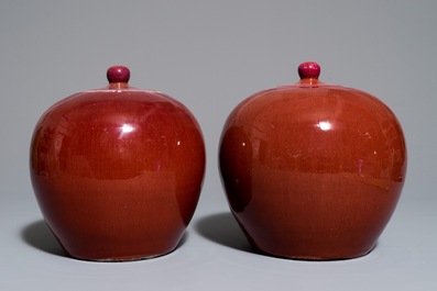 A pair of Chinese monochrome oxblood-glazed ginger jars and covers, 19th C.