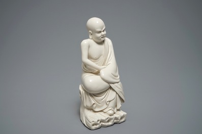 A Chinese Dehua blanc de Chine figure of a Luohan, 19th C.