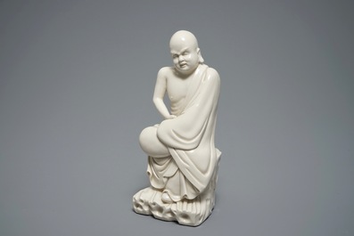 A Chinese Dehua blanc de Chine figure of a Luohan, 19th C.
