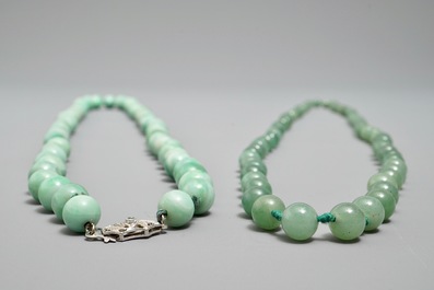 Two Chinese green jade beads necklaces, one with silver lock, 19/20th C.