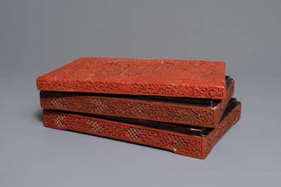 A rectangular Chinese cinnabar lacquer three-tier box and cover with figures in a garden, 19th C.