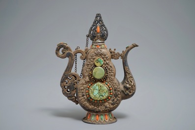 A silvered and parcel-gilt brass jug inlaid with turquoise and coral, Tibet or Mongolia, 19th C.