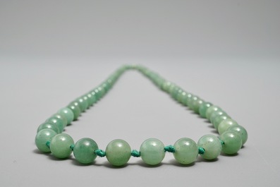 Two Chinese green jade beads necklaces, one with silver lock, 19/20th C.