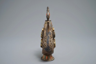 A silvered and parcel-gilt brass jug inlaid with turquoise and coral, Tibet or Mongolia, 19th C.