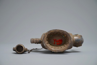 A silvered and parcel-gilt brass jug inlaid with turquoise and coral, Tibet or Mongolia, 19th C.