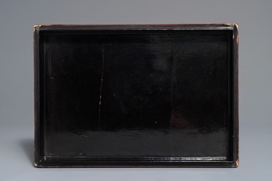 A rectangular Chinese cinnabar lacquer three-tier box and cover with figures in a garden, 19th C.