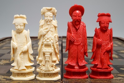 A Chinese lacquered chess and backgammon board with ivory chessmen, 19th C.