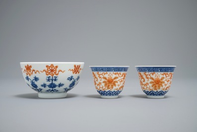 A pair of Chinese iron red and blue cups and a bowl, Qianlong and Guangxu marks, 19/20th C.