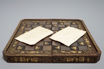 A Chinese lacquered chess and backgammon board with ivory chessmen, 19th C.