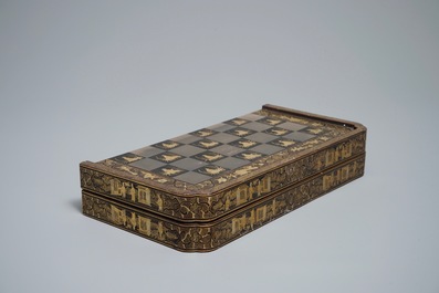 A Chinese lacquered chess and backgammon board with ivory chessmen, 19th C.