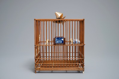 A Chinese wooden bird cage with ivory and porcelain ornaments, 19/20th C.