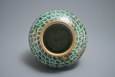 A Chinese famille verte vase with mythical beasts on a ground of waves, 19th C.