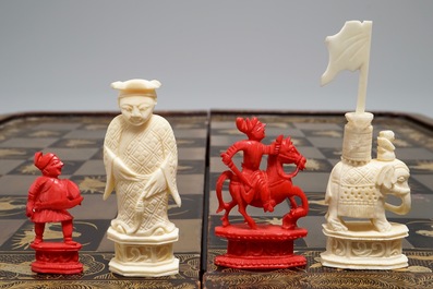 A Chinese lacquered chess and backgammon board with ivory chessmen, 19th C.