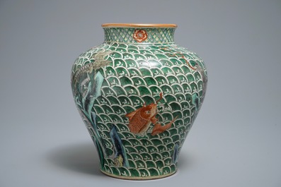 A Chinese famille verte vase with mythical beasts on a ground of waves, 19th C.