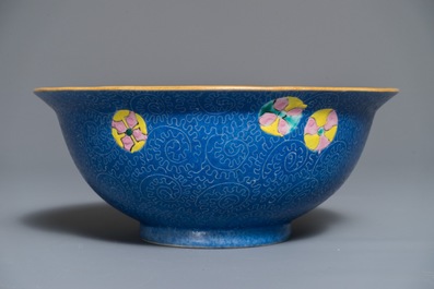 A Chinese famille rose blue ground sgraffiato bowl, Qianlong mark, 19th C.