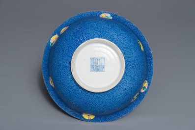 A Chinese famille rose blue ground sgraffiato bowl, Qianlong mark, 19th C.