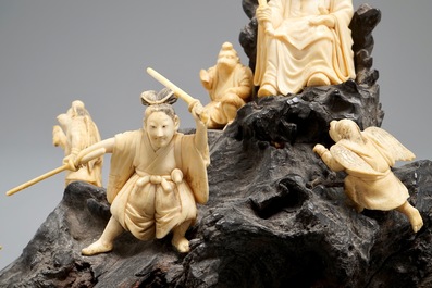 A Japanese carved ivory group on rootwood base, prob. Tokyo school, Meiji, 19th C.