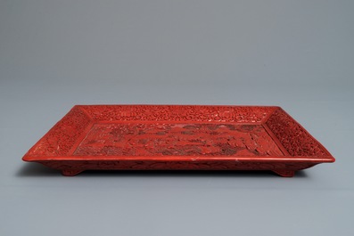 A rectangular Chinese cinnabar lacquer tray with figures in a landscape, 18/19th C.