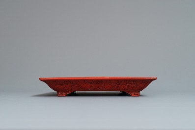 A rectangular Chinese cinnabar lacquer tray with figures in a landscape, 18/19th C.