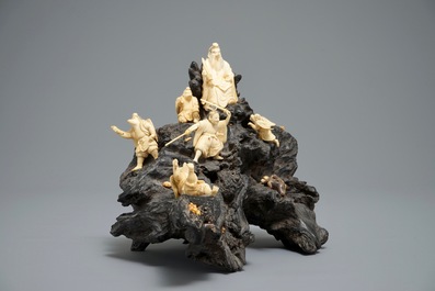 A Japanese carved ivory group on rootwood base, prob. Tokyo school, Meiji, 19th C.