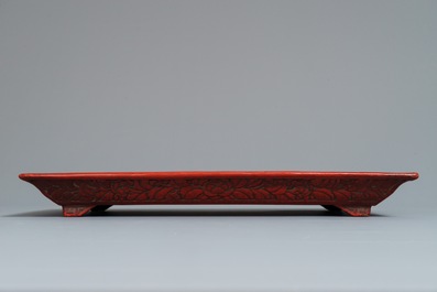 A rectangular Chinese cinnabar lacquer tray with figures in a landscape, 18/19th C.