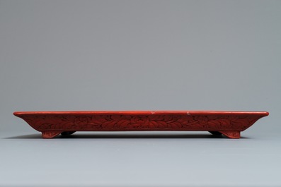 A rectangular Chinese cinnabar lacquer tray with figures in a landscape, 18/19th C.