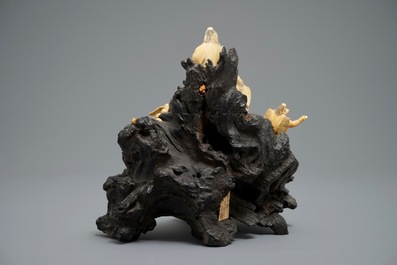 A Japanese carved ivory group on rootwood base, prob. Tokyo school, Meiji, 19th C.