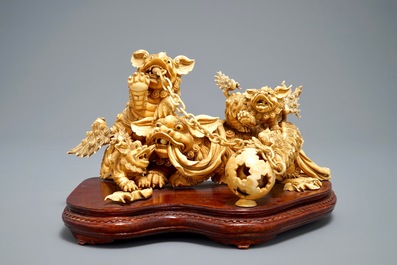 A Chinese carved ivory group of Buddhist lions playing with a ball, 19/20th C.