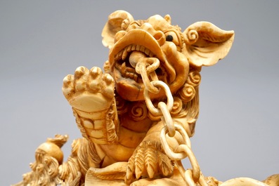 A Chinese carved ivory group of Buddhist lions playing with a ball, 19/20th C.