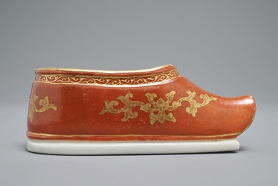A Chinese coral-ground and gilt miniature shoe with hidden famille rose erotical design, 19/20th C.