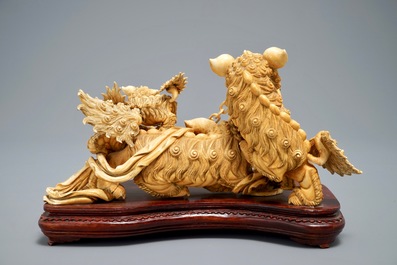 A Chinese carved ivory group of Buddhist lions playing with a ball, 19/20th C.