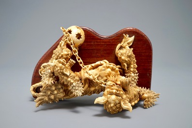 A Chinese carved ivory group of Buddhist lions playing with a ball, 19/20th C.