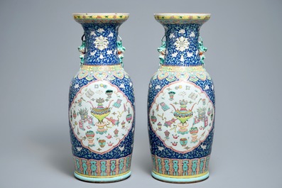 A pair of Chinese famille rose blue-ground vases, 19th C.