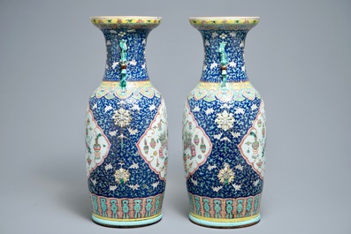 A pair of Chinese famille rose blue-ground vases, 19th C.