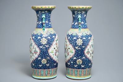 A pair of Chinese famille rose blue-ground vases, 19th C.