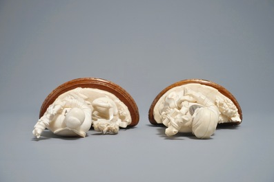 Two Chinese carved ivory figures of sages on wooden stands, 1st half 20th C.