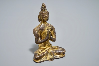 A Nepalese parcel-gilt bronze Buddha Namaskara, 16/17th C.