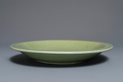 A Chinese Longquan celadon charger with underglaze floral design, Ming