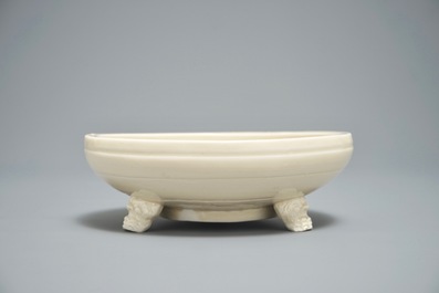 A Chinese monochrome cream-glazed vase and a tripod censer, Ming