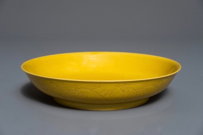 A Chinese monochrome yellow dish with incised lotus design, Kangxi mark, 20th C.