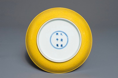 A Chinese monochrome yellow dish with incised lotus design, Kangxi mark, 20th C.