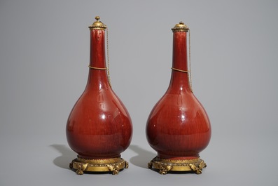 A pair of Chinese gilt bronze-mounted oxblood-glazed vases, 19th C.
